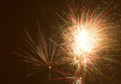 Low angle view of firework display at night