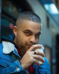 Portrait of young man having drink