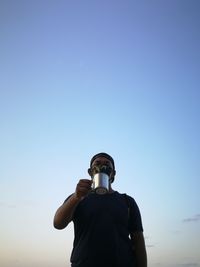 Low angle view of man standing against sky