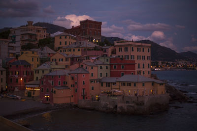 Buildings in city against sky at dusk