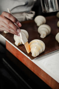 Close-up of person preparing food on cutting board