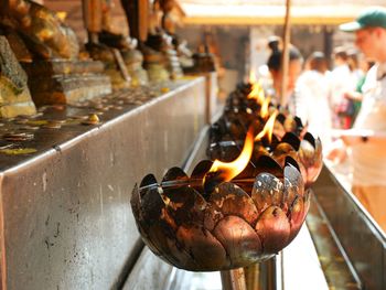 Close-up of burning candles in temple