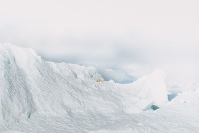 Scenic view of snow covered landscape against sky