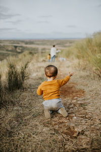 Rear view of boy on field