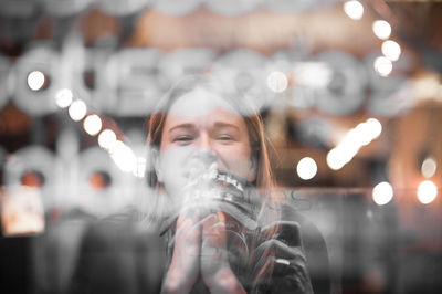 Portrait of woman seen through glass window