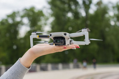 Girl  controls the remote control from a flying drone of modern technology