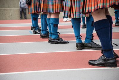 Low section of schoolgirls standing on ground