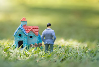 Figurine and model house on land