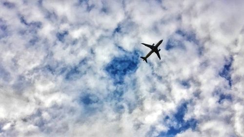 Low angle view of airplane flying in sky