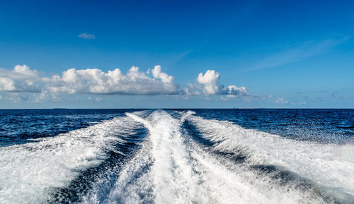 Panoramic view of sea against blue sky