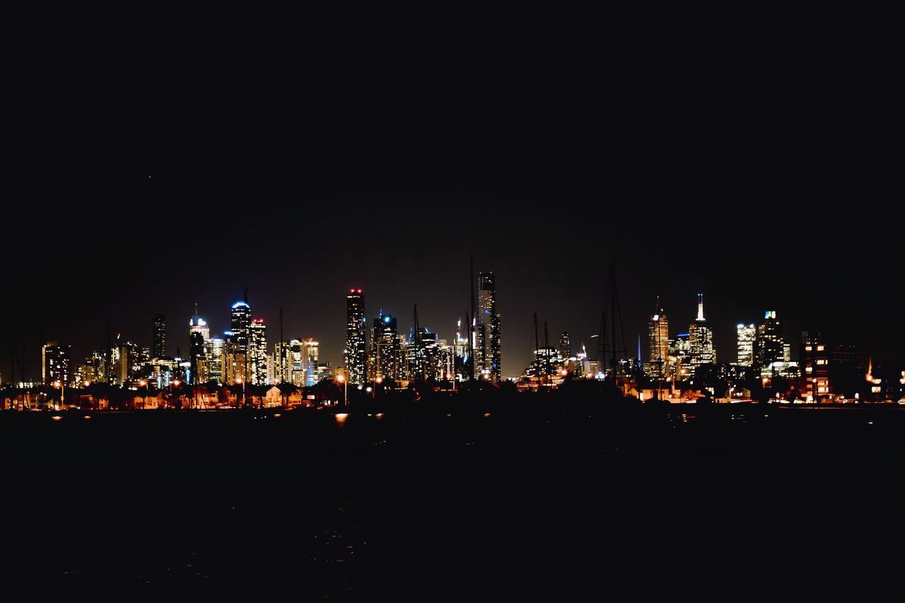 VIEW OF ILLUMINATED CITYSCAPE AGAINST SKY AT NIGHT