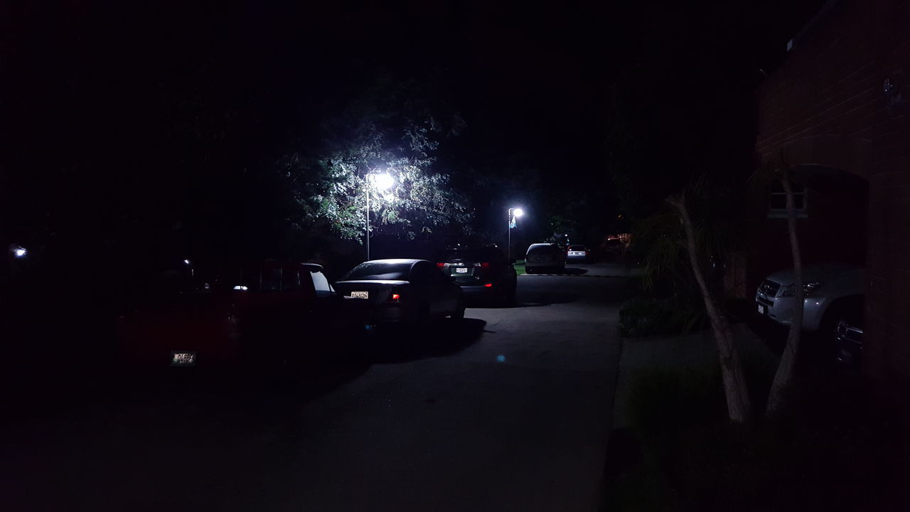 CARS PARKED ON ROAD AT NIGHT