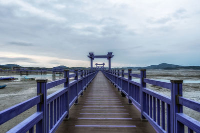 Pier over sea against sky