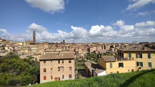 Buildings in town against sky