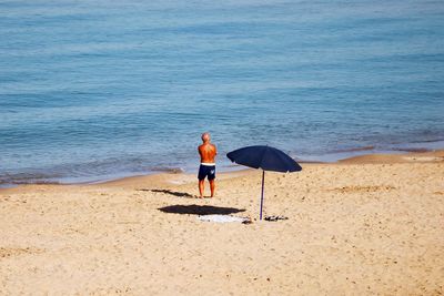 Full length of man standing on beach