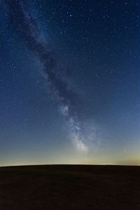 Scenic view of landscape against sky at night