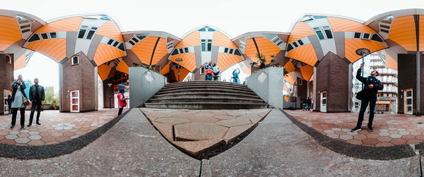 Group of people walking on tiled floor in city