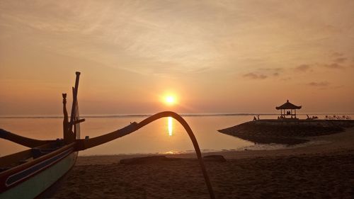 Scenic view of beach against sky during sunset