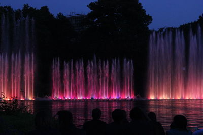 Illuminated fountain at night