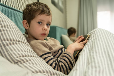 Portrait of boy sleeping on bed at home