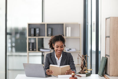 Young woman using laptop while sitting at home