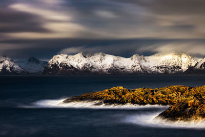 Scenic view of snowcapped mountains against sky during sunset