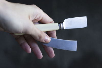 Close-up of hands holding metal
