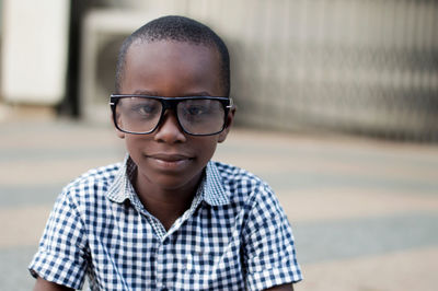 Little boy happy to wear his mother's glasses.