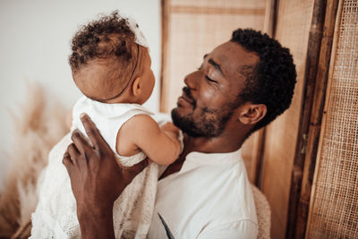 Man with son standing on floor