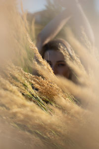 Portrait of young woman standing amidst plants