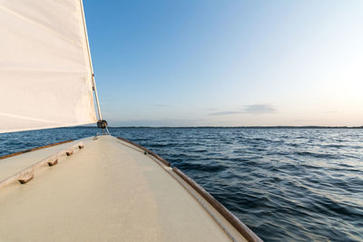 Sailboat sailing on sea against clear sky