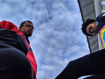 Low angle view of young couple against sky