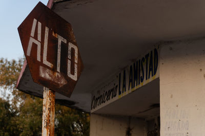 Low angle view of text on rusty metal