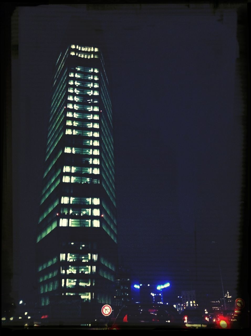 illuminated, architecture, building exterior, night, built structure, low angle view, city, transfer print, auto post production filter, modern, skyscraper, building, office building, tall - high, city life, tower, sky, no people, tall, outdoors