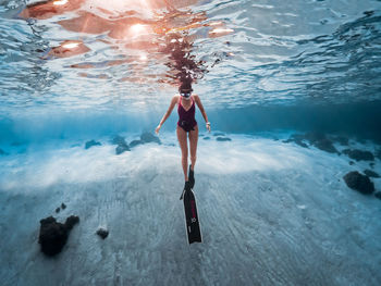 Digital composite image of woman standing in swimming pool