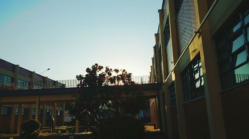 Buildings in city against clear sky