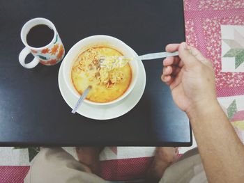 Cropped image of hand holding coffee