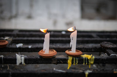 Close-up of illuminated candles on temple