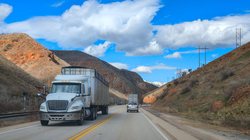 Cars on road against sky