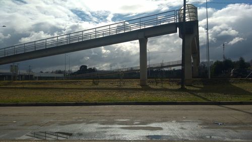 Bridge over road against sky