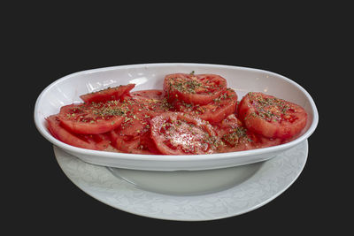 Close-up of strawberries in bowl against black background