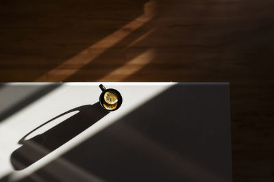 High angle view of herbal tea with lemon in cup on table