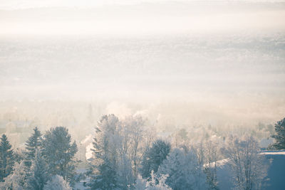 Scenic view of snow covered land against sky