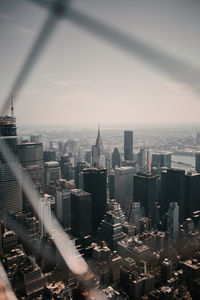 Chainlink fence against buildings in city