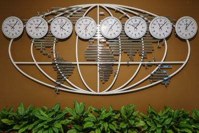 Close-up of clocks hanging against wall