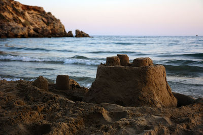 Sandcastle on the seashore in the evening.