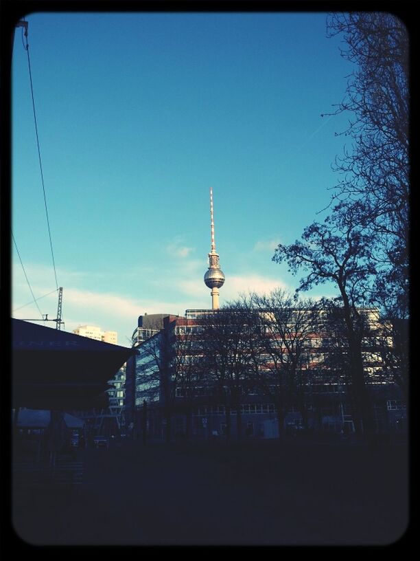 communications tower, architecture, built structure, building exterior, tower, transfer print, communication, spire, fernsehturm, city, tall - high, sky, television tower, travel destinations, capital cities, international landmark, famous place, culture, auto post production filter, tourism