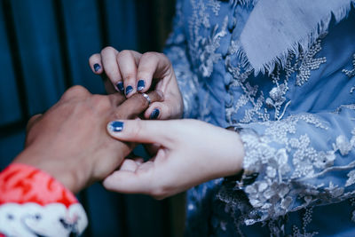 Midsection of woman holding hands in wedding proposal