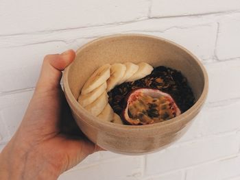 Close-up of hand holding bowl