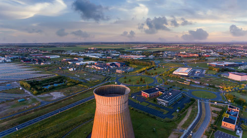 Old metal factory chimney in caen, colombelles, normandy, drone photo at sunset, industrial area